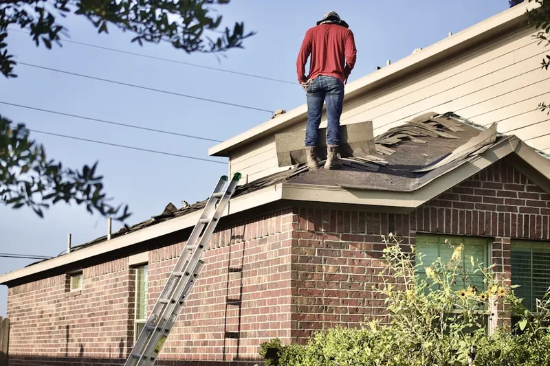 Professional roofer working on a residential roof in Arrowhead Meadows